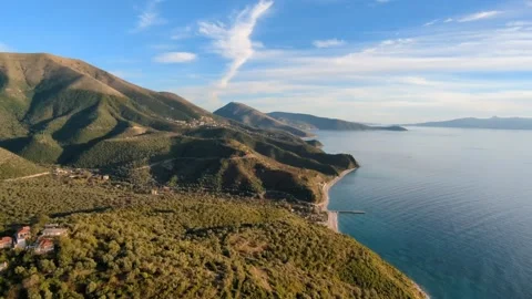 Powered paragliding paramotor flying over Albanian coast mountains and beaches Stock Footage 317489026