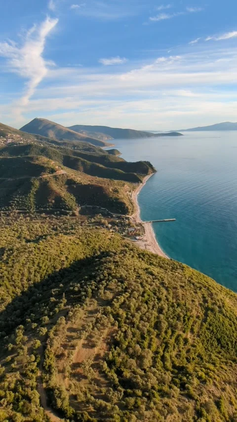 Powered paragliding paramotor flying over Albanian coast mountains and beaches Stock Footage 317489094