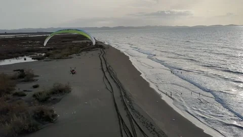 Powered paragliding paramotor flying over Albanian coast mountains and beaches Vídeos de archivo 332948081