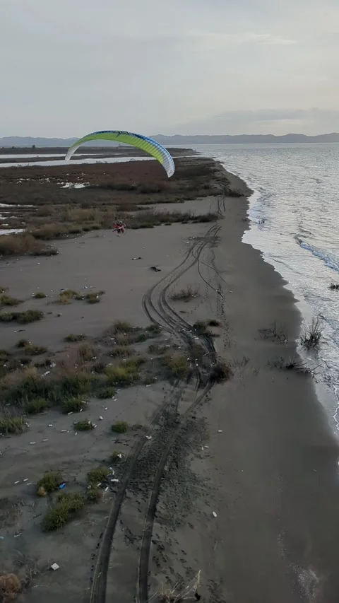 Powered paragliding paramotor flying over Albanian coast mountains and beaches Vídeos de archivo 332948085