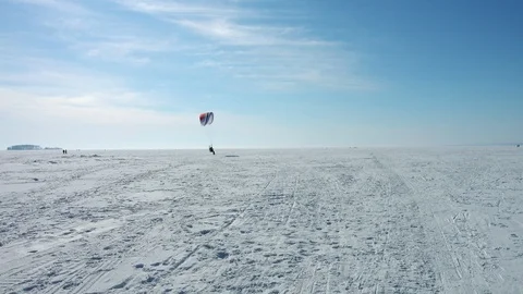 Powered paragliding ppg flight above frozen sea Stock Footage 87898412