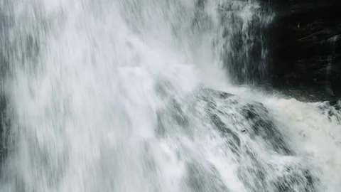 Powerful and dramatic waterfall with water gushing over granite rocks very Video stock 130369826