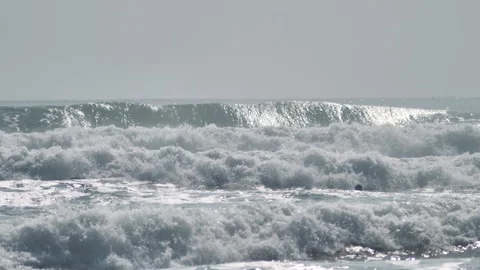 Powerful and rapid splash of shining waves in the sea on a summer day. Stock Footage 154534839
