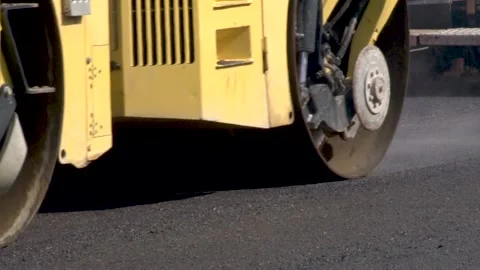 Powerful asphalt rollers drive along new road to press covering. Stock Footage 234206158