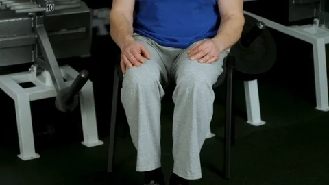 A powerful athlete makes isometric exercise by resisting kneeling .front view Stock Footage 115250821