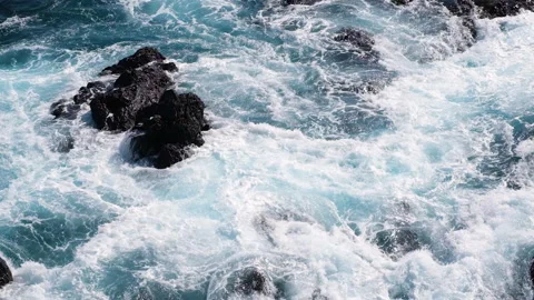 Powerful Atlantic Ocean waves crashing against volcanic rocks on the coast of Stock Footage 345960538