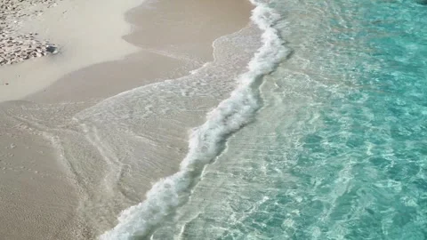 A powerful blue ocean wave creates a white foam splash against the nature coast  Stock Footage 329141662