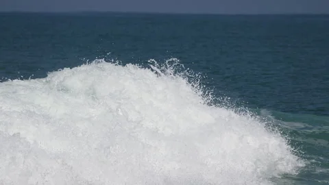 Powerful boat wake splashing in blue ocean water Stock Footage 340642244