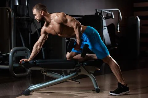 Powerful bodybuilder with dumbbell Stock Photos