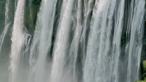 Powerful cascading water falling down a massive cliff at Huangguoshu Waterfall Stock-Footage 342277637