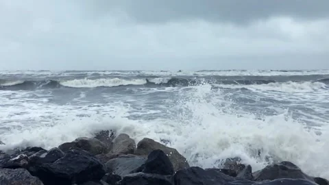 Powerful Caspian Sea waves crash against rocky shore under stormy grey clouds Stock Footage 336245373