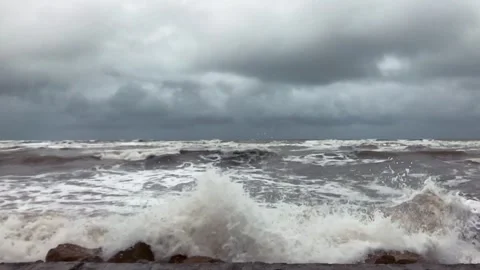 Powerful Caspian Sea waves crash against rocky shore under stormy grey clouds Stock Footage 336245411