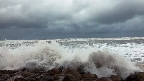 Powerful Caspian Sea waves crash against rocky shore under stormy grey clouds Stock Footage 336245418