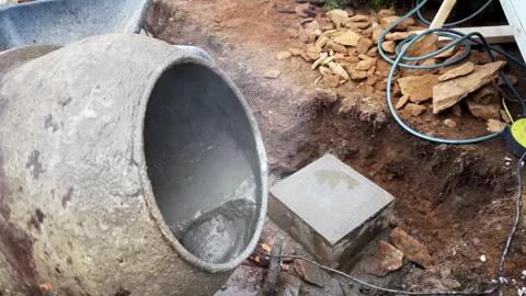 Powerful cement mixer rotates as dry cement and sand are manually added Stock-Footage 306591052