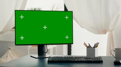 Powerful computer with chroma key green screen mock up stands on desk Stock Photos
