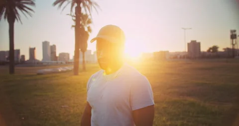Powerful confident black guy standing at urban park resting at training session Stock Footage 140739374