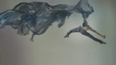 Powerful contemporary ballet dance movements with large flowing textile fabrics Stock Footage 233700207
