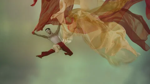 Powerful contemporary ballet dance movements with large flowing textile fabrics Stock Footage 233700295