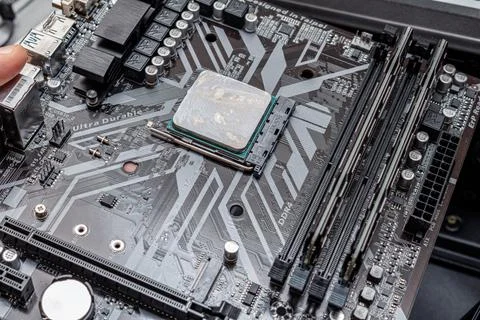 Powerful CPU with applied thermal grease on a personal computer. The process  Stock Photos