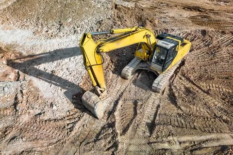 A powerful crawler excavator is working on a construction site. Close-up. Vie Stock-Fotos