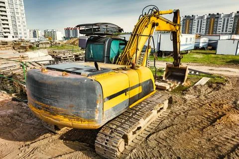 A powerful crawler excavator is working on a construction site. Close-up. Pre Photos