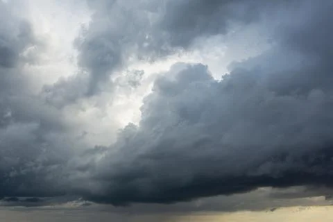 Powerful cumulus clouds with a dark base, a harbinger of bad weather and heav Stock Photos