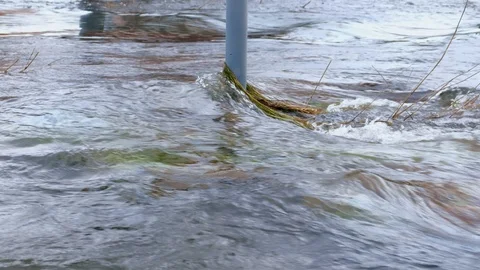 Powerful current flooding in city at spring. Flooded communications on street. Stock Footage 117896196