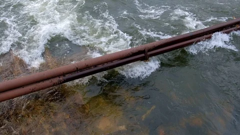 Powerful current flooding in town at spring. Flooded communications on street. Stock Footage 117711562