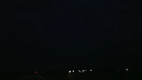 Powerful dangerous thunderstorm lightning bolt striking over the deserted road Stock Footage 115669275