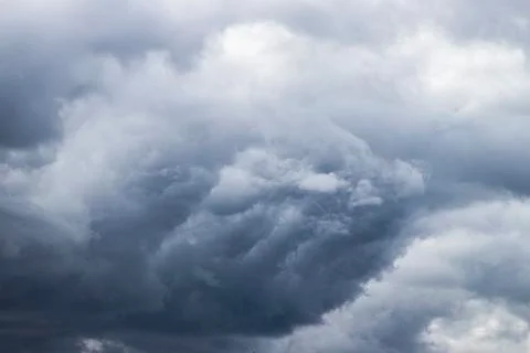 A powerful dark blue cloud carries thunder and rain. Stock Photos