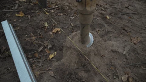 Powerful drill rotates deep into soft loose soil closeup Vídeos de archivo 313833153