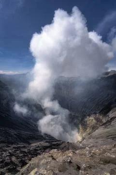 A powerful erupting volcano is spewing ash clouds high into the atmosphere,.. Stock Photos