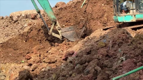 Powerful Excavation Operations: Teal Digger Precisely Reshaping Terrain at .. Video stock 337286829