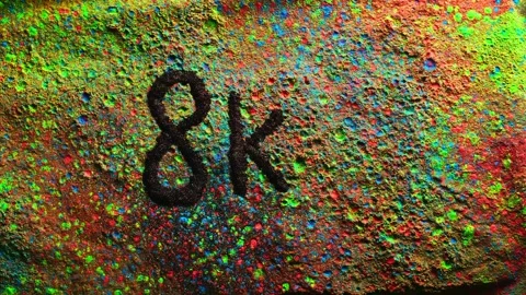 Powerful explosion of multi colored powder word or number 8k.Slow motion video Stock Footage 255198657