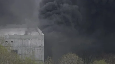 Powerful fire during construction school building. Strong black smoke billows Stock Footage 155364696