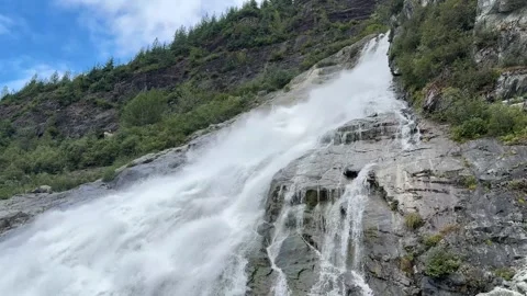 The powerful flow of the waterfall, Nugget Falls, Alaska, August 2025, with.. Stock Footage 334359892