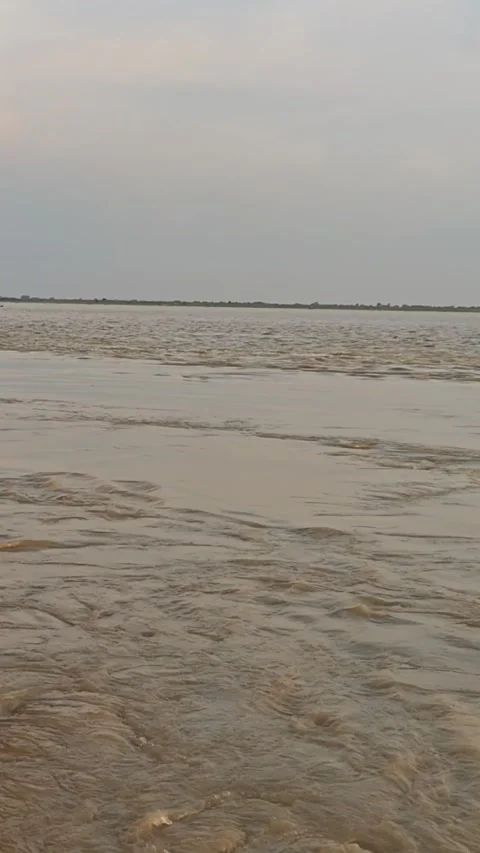 Powerful Flowing River Water with Muddy Ripples and Wide Horizon Stock Footage 340518316