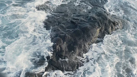 Powerful Foaming Wave Tide Against Surround on Reef Rock Stock Footage 128946413