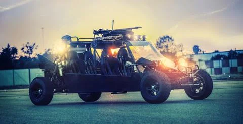 Powerful formidable buggy with the lights on ready to ride on an airport track Stock Photos
