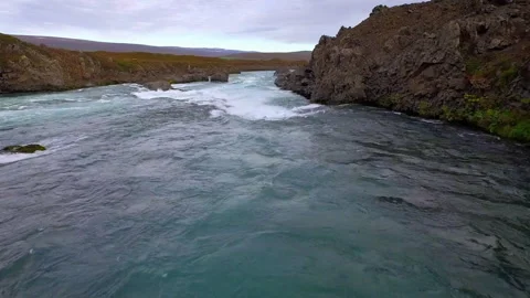 Powerful glacial river flowing through Iceland canyon Stock Footage 330282244