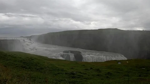 Powerful Gullfoss waterfall with heavy water mist and green cliffs, Iceland Stock Footage 334870935