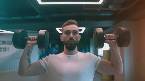 Powerful healthy man is training shoulder, Dumbbell lateral raise. Stock Footage 119388255