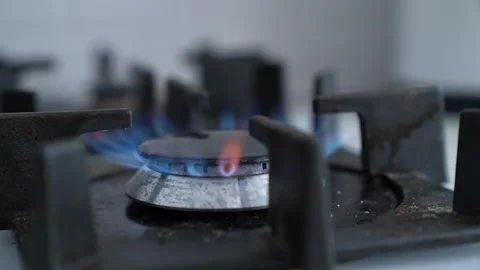 Powerful heat source close-up, gas stove burners lit, efficient kitchen heating Stock Footage 312725262