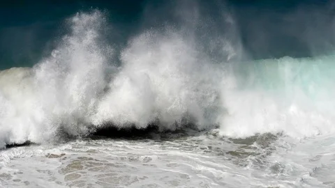 Powerful huge turquoise ocean wave crushing against the rocky coast transforming Stock-Footage 107179568