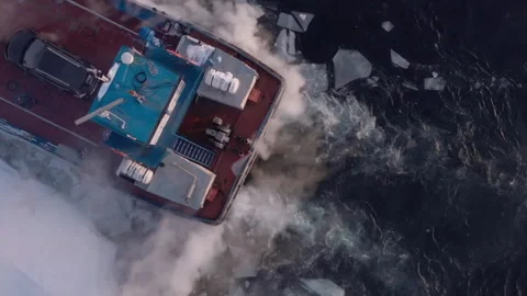 Powerful icebreaker ship navigating through frozen sea Stockbeeldmateriaal 335078002