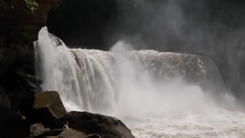 Powerful Jungle Waterfall Cascading into River with Mist and Rocks Stock Footage 341981961
