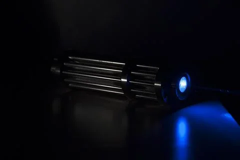 Powerful laser pointer, blue laser capable of burning paper and leaving burns Stock Photos