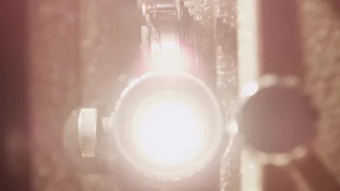 Powerful light beam emitting from a retro projector lens Stock Footage 329743735