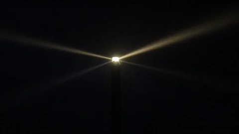 Powerful lighthouse illuminated at dusk Stock Footage 95798172