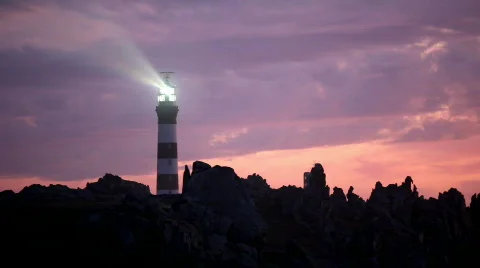 Powerful lighthouse illuminated in sunset Stock Footage 516158